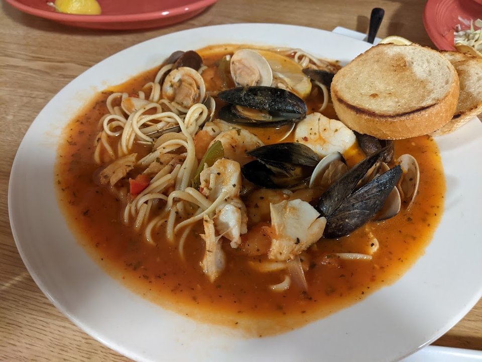 Printed menu showing seafood and Latin dishes.